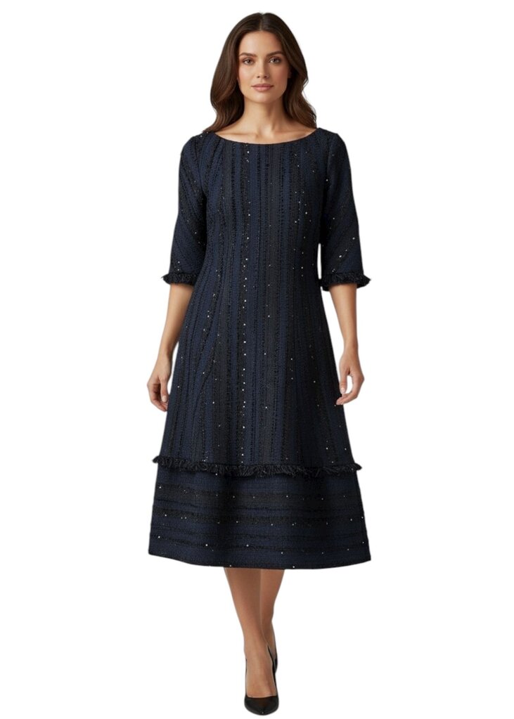 Woman wearing a navy dress with intricate detailing on a white background